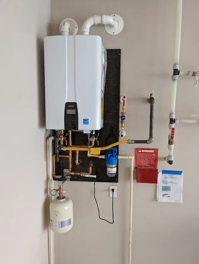 Professional plumber installing copper piping in a Lexington home